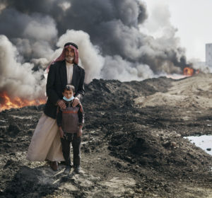 Nadak Aziz and Kharim Ali, a village elder an a young boy pose for a portrait near the Qayyarah oil fires. October 25th, 2016. Joey L./Oxfam